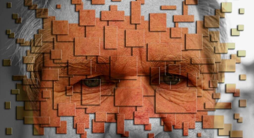 A face in orange of a sad man build out of puzzles. The sorrow in the context of social stigma