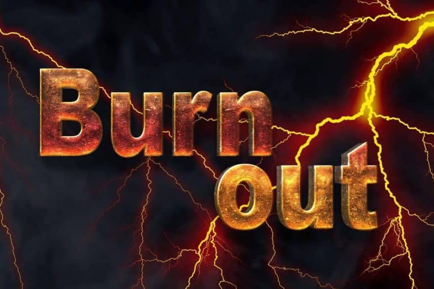 Abstract picture showing the sentence "Burn out". In the background on a brown background lightning. The letter of the sentence are coloured in yellow and red. It looks like fire