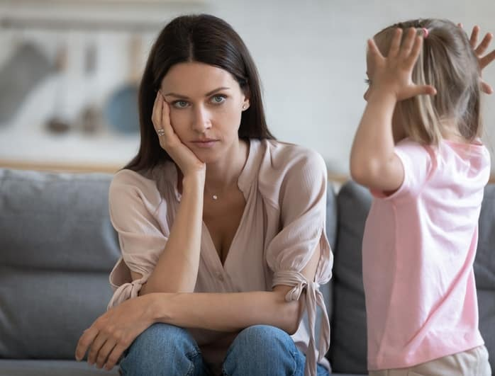 ADHD in Children. Picture shows desperate mother looking at her adhd child